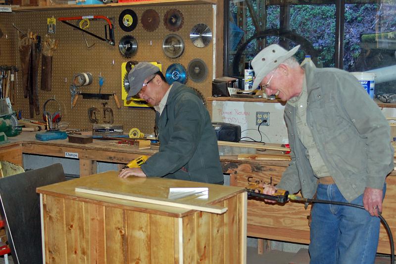 Leland and Art With Cabinet.jpg - Leland Wong (left) and Art Holtz working on one of the cabinets they refaced.